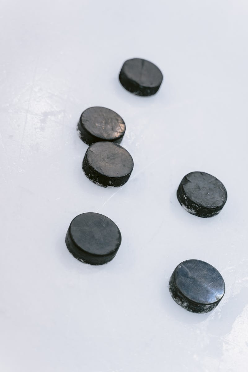 Hockey Pucks on Ice Field