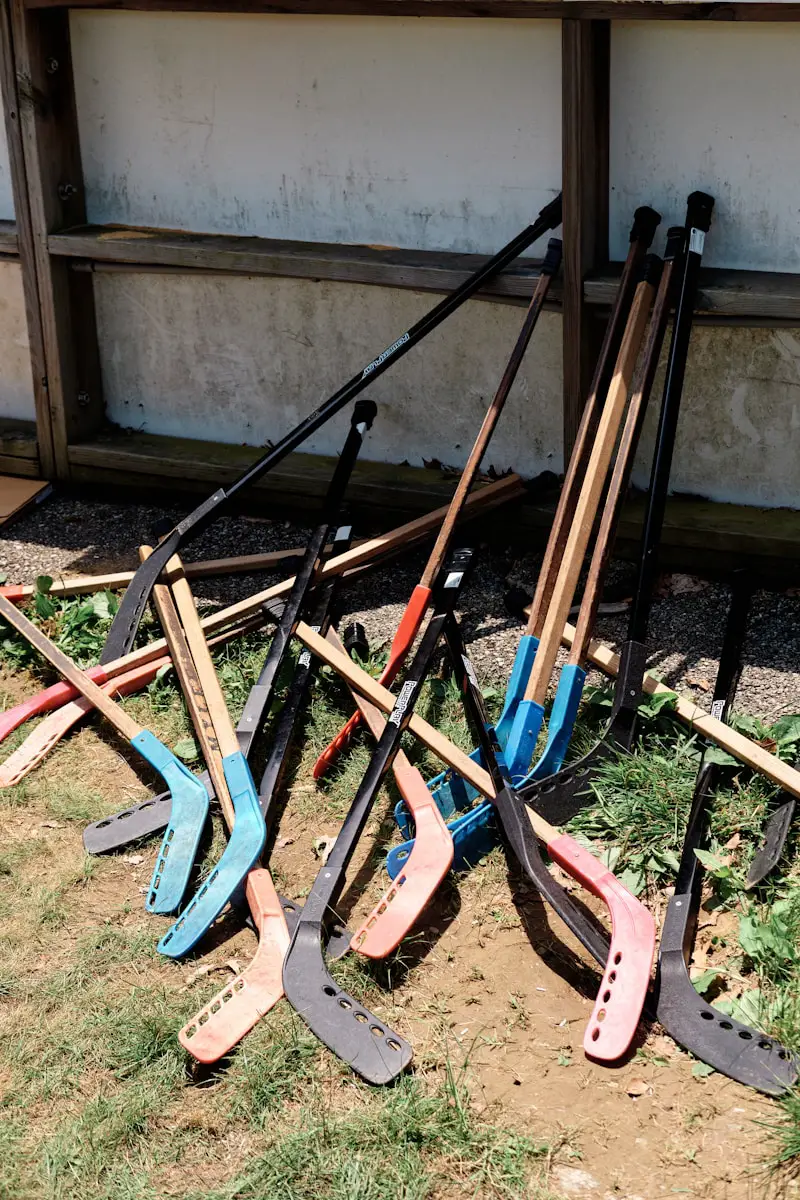 a pile of shovels sitting on top of a grass covered field